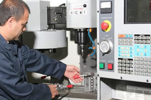 Man Working CNC Machining Mill